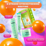 A promotional image for Amika's 'Play Your Strength' strand-strengthening routine set, featuring the products included in the set displayed against a colorful sky with floating orange balloons. The top banner reads 'A Strand-Strengthening Routine' in an orange and white gradient. The products are labeled with their specific functions: 'cleanse' next to The Kure Bond Repair Shampoo, 'condition' next to The Kure Bond Repair Conditioner, and 'intense weekly treatment' next to The Kure Intense Bond Repair Mask.